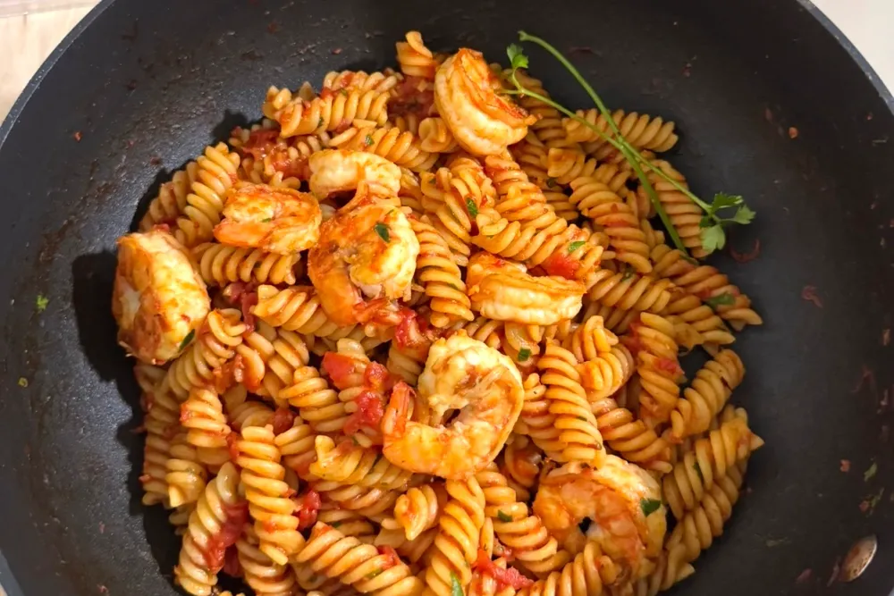 Shrimp pomodoro — prawns and fusilli pasta in a red tomato sauce with parsley, in a pan